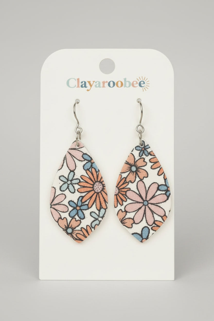 Teardrop-shaped dangle earrings with a pink, orange, and blue floral pattern on a white background, displayed on a white Clayaroobee card.