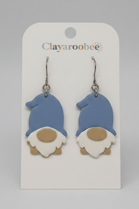 A pair of gnome-shaped dangle earrings displayed on a white card labeled Clayaroobee